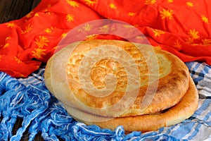 Fatir, uzbek flatbread on blue arab scarf and red cloth