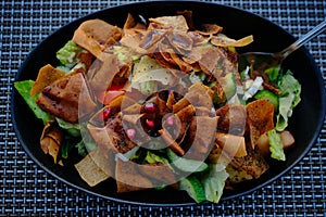 Fattoush Lebanese salad close up  image in a black plate .