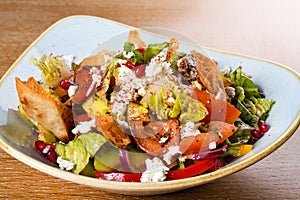 Fattoush is a Levantine salad made from toasted or fried pieces of khubz combined with mixed greens