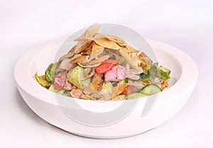 FATTOUSH salad with cucumber, crackers, onion, tomato and lemon served in dish isolated on background side view of arab food
