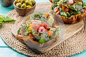 Fattoush served in dish isolated on wooden table side view of middle eastern food