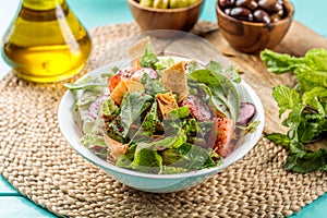 Fattoush served in dish isolated on wooden table side view of middle eastern food