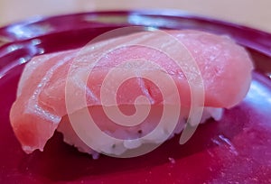 Fatty tuna sushi on red dish