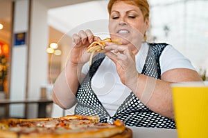 Fatty woman eating pizza with french fries