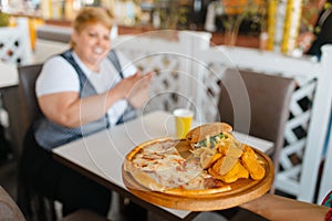 Fatty woman prepares to eats fastfood