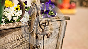 Faucet as deco in old with rust on a wooden cart with planted flowers