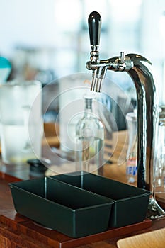 Shiny faucet for a classic draft beer in a restaurant