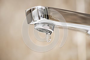 Faucet with dripping water. Tap closeup with dripping water-drop. Water leaking, saving concept