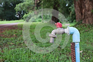 Faucet installed in outdoor park, water saving concept.