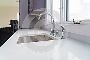 Faucet and kitchen sink with brick wall