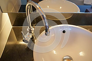 Faucet and luxury washbasin in luxury hotel bathroom for face and hand wash