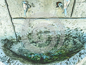 Faucet in muslim temple, islamic religion. a stone sink stands on the street. silver faucet for washing hands. faucet with valves