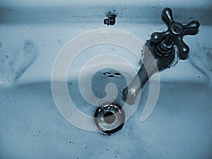 Faucet of an old and deteriorated washbasin