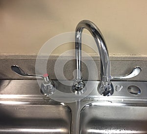 Faucet in the Sink of a Bathroom, Washroom or Kitchen