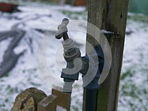 Faucet tap in garden in winter