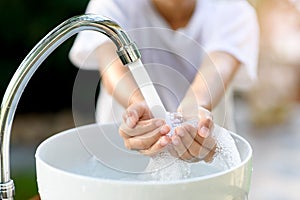 Faucet water and hand