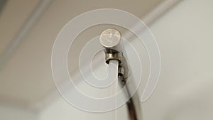 Faucet water rushes out with strong pressure. Water rushes from a water faucet made of stainless steel. limescale on the faucet