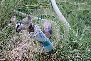 Water faucet with grass at outdoor house