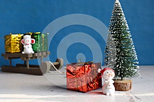 Faux Christmas tree and gifts on little sleigh. Happy New Year and Merry Christmas concept.Greeting card or festive background.
