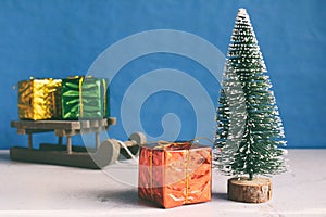 Faux Christmas tree and gifts on little sleigh. Happy New Year and Merry Christmas concept.Greeting card or festive background. photo