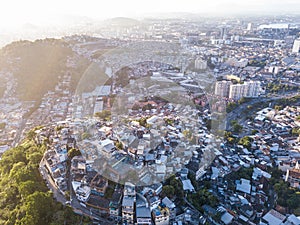 Favelas house on the hills. Aerial photo of city Rio de Janeiro Brazil. narrow streets of the poor . Beautiful sunset