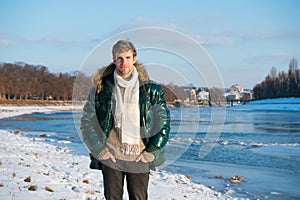 Favorite season is here. guy green puffer coat. man enjoy winter landscape. nature is beautiful. place for thoughts photo