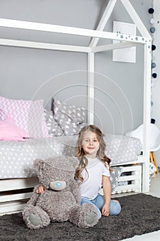 Favorite toy. Girl child sit on bed hug teddy bear in her bedroom. Kid prepare to go to bed. Pleasant time in cozy bedroom. Girl k