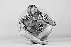 favorite tune. Portrait of happy bearded male playing guitar. a lonely musician. cheerful handsome mature man playing