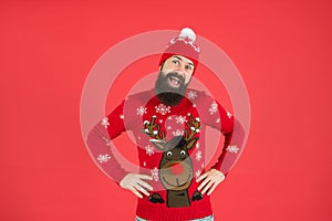 Favorite winter season indoor activities. Hipster bearded man wear winter sweater and hat red background. Happy new year