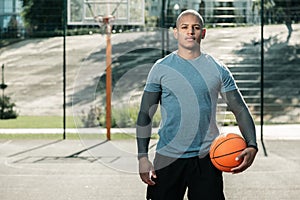 Serious Afro American man standing with a ball photo