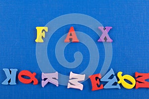 FAX word on blue background composed from colorful abc alphabet block wooden letters, copy space for ad text. Learning