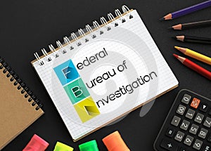 FBI - Federal Bureau of Investigation acronym on notepad, concept background