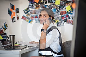 FBI woman in office talking on phone. photo