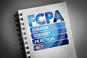 FCPA - Foreign Corrupt Practices Act acronym on notepad, business concept background