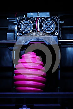 FDM 3D-printer manufacturing wound pink easter egg sculpture - front view on object and print head - portrait composition