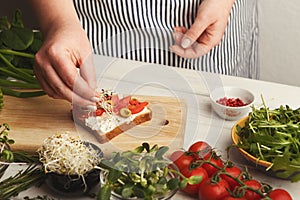 Feamale hands making healthy bruschettas for right snack