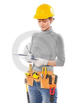 Feamale worker with construction tools holding clipboard writing