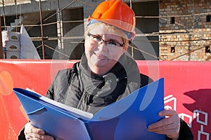 Feamle Engineer in the construction helmet