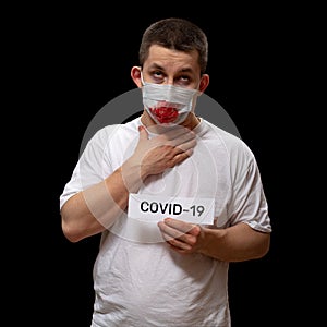 Fear of Contracting COVID-19 coronavirus. A man coughs blood into a medical mask