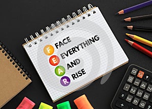 FEAR - Face Everything And Rise acronym text on notepad, concept background