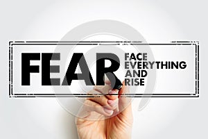 FEAR - Face Everything And Rise acronym text stamp, concept background
