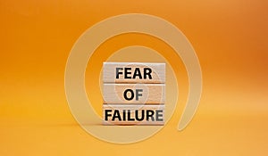 Fear of failure symbol. Concept words Fear of failure on wooden blocks. Beautiful orange background. Business and Fear of failure