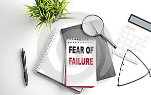 FEAR OF FAILURE text on notebook on white wooden background , business concept