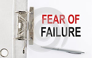 FEAR OF FAILURE text on the paper folder with pen. Business concept