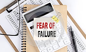 FEAR OF FAILURE word on sticky with clipboard and notebook, business concept