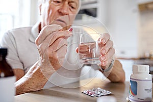 Fear of growing old. an elderly man taking his medication at home.