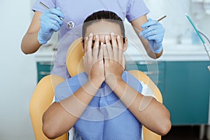 Fear, horror and fright expresses little girl in dental clinic