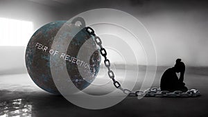 Fear of rejection - a metaphorical view of a woman struggle with fear of rejection. Trapped alone and chained to a burde