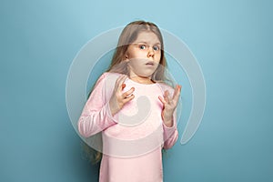 The fear. Teen girl on a blue background. Facial expressions and people emotions concept