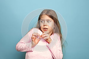 The fear. Teen girl on a blue background. Facial expressions and people emotions concept